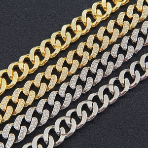 Flat 13mm Cuban link chains in gold and silver with iced out rhinestones on black background