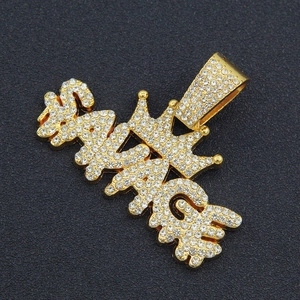 Macro shot of gold-plated SAVAGE letter pendant with crown and shimmering diamonds
