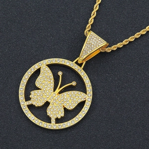 Macro view of iced-out butterfly pendant with sparkling rhinestones and gold rope chain