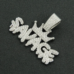 Macro shot of silver hip-hop SAVAGE letter pendant with crown and white rhinestones