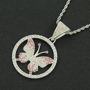 Macro shot of silver hip hop necklace with pink rhinestone butterfly pendant
