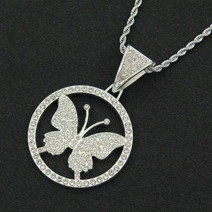 Close-up of iced out butterfly pendant with silver plating and twisted rope chain