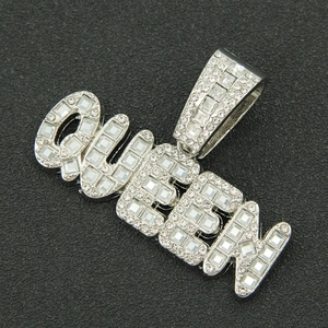 Macro shot of silver QUEEN letter pendant with paved rhinestones on black background
