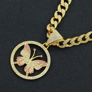 Close-up of hip-hop gold Cuban chain with pink and white crystal butterfly pendant