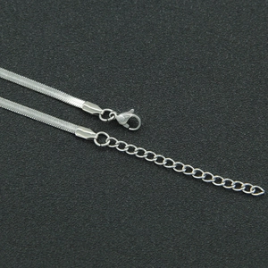 Detail view of silver stainless steel flat snake chain necklace with lobster clasp