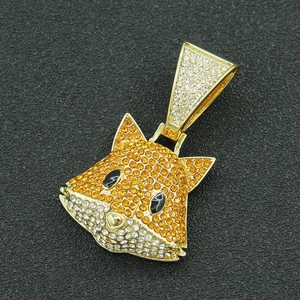 Close-up of hip-hop 3D fox pendant with orange and white crystals on black background