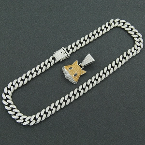 Macro view of iced out silver fox head pendant with sparkling stones on Cuban link chain