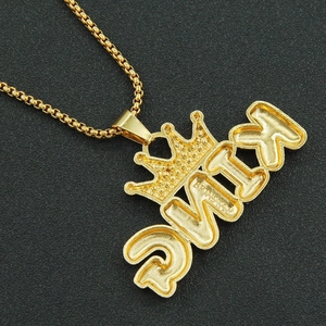 Detailed macro view of gold-plated queen pendant with crown and shimmering stones