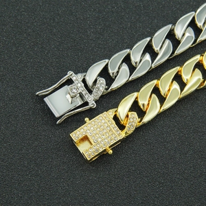Chunky gold and silver cuban link chains with iced out diamond encrusted clasps
