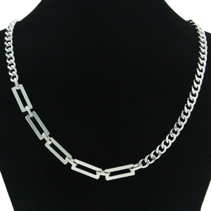 Minimalist silver asymmetric Cuban link necklace displayed on a black mannequin