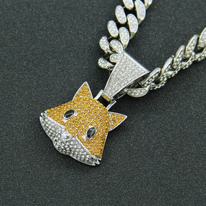 Macro shot of iced-out fox head pendant with sparkling rhinestones on Cuban link chain