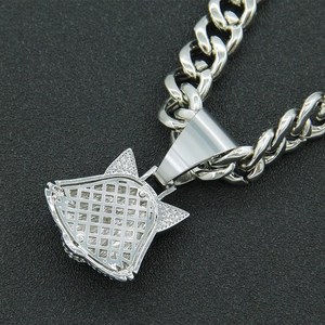Detailed macro shot of the silver-tone metal wolf pendant with intricate hollow grid back