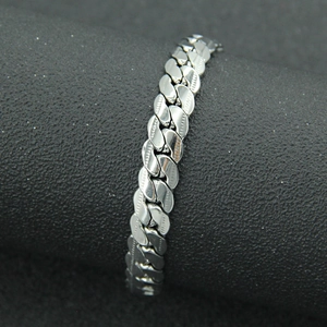 Punk style silver Cuban link bracelet with polished finish and decorative side grooves