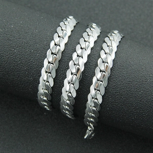Polished silver cuban link chain with textured edges displayed on black background