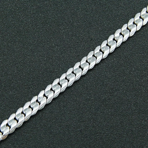 Polished silver Cuban link bracelet with textured edges in a minimalist steel design