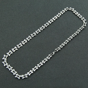 Detail of silver bone-shaped chain necklace with polished finish and lobster clasp