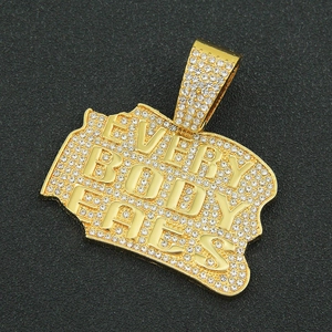 Detail of hip hop gold pendant with Everybody Eats letters and iced out stones
