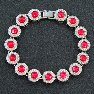 Detail of hip-hop silver bracelet with red round stones and white diamond accents