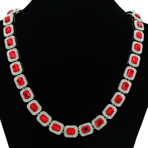 Detailed close-up of Cuban link necklace featuring rectangular red ruby and micro-pave crystals