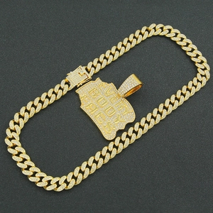 Detailed close-up of iced-out gold Cuban link chain with 'EVERY BODY EATS' pendant