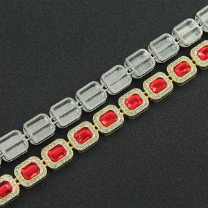 Detail of hip hop bracelet showing comparison between gold red diamond and silver base