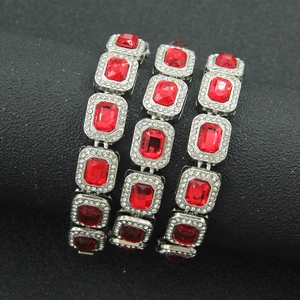 Detailed macro view of red rectangular crystal link bracelet with silver finish