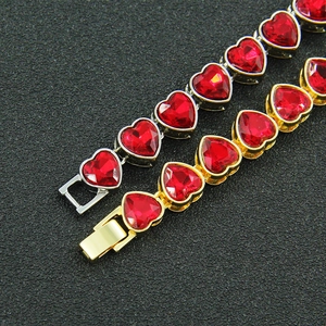 Dettaglio di bracciali tennis con zirconi rossi a cuore, placcati in oro e argento