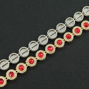 Macro detail of gold and silver hip hop link bracelets with red gems and rhinestones