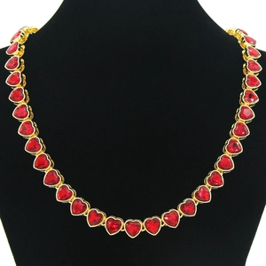 Hip hop heart necklace with red ruby stones and gold plating on a black neck model