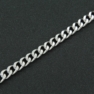 Macro detail of silver stainless steel Cuban link chain with high polish finish