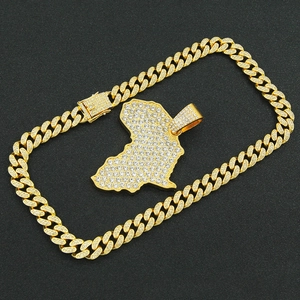 Macro shot of gold-plated iced-out Africa map pendant on thick Miami Cuban link chain
