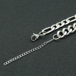 Detail view of silver Figaro and Curb chain拼接 with lobster clasp and extender