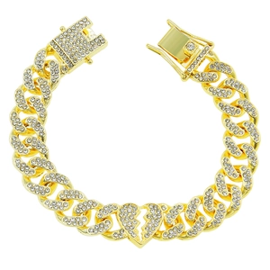 Macro view of iced out gold Cuban link bracelet featuring a sparkling broken heart pendant