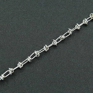 Detailed close-up showing the polished silver industrial chain link texture and design