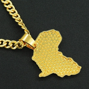 Close-up of gold Africa map pendant with relief texture on heavy Miami Cuban chain