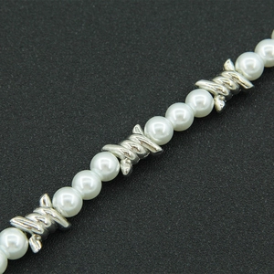 Detailed close-up of mixed pearl and silver-tone punk barbed wire necklace link