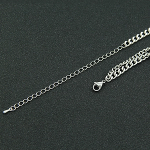 Detailed close-up of the adjustable silver stainless steel Cuban chain link and lobster clasp
