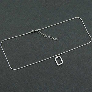 Silver snake chain necklace with a textured hollow rectangular pendant in titanium steel
