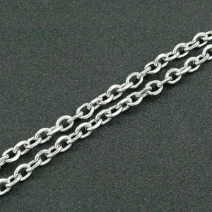 Macro shot of polished silver cable chain links in stainless steel jewelry necklace