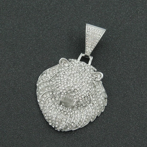 Gros plan du pendentif tête de lion hip hop avec strass étincelants sur fond noir