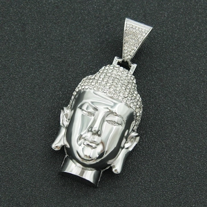 Close-up of a silver Buddha head pendant with micro-pave white zircon stones on a black base
