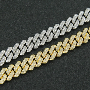 Detailed view of hip-hop Cuban link chain with icy rhinestone pave in gold and silver