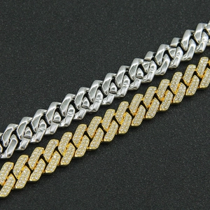 Detail of silver polished and gold diamond-encrusted cuban link bracelets for men