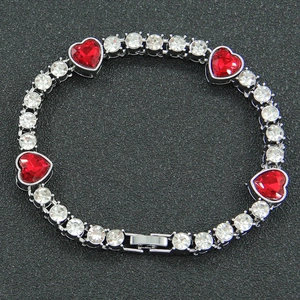 Close-up of hip-hop silver necklace with red heart gems and sparkling zircon stones