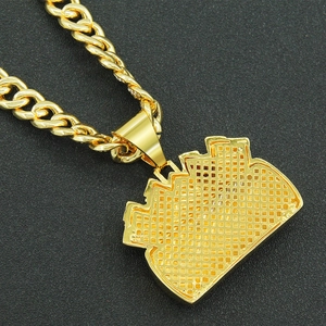 Detail of the golden crown pendant back showing precision honeycomb hollow structure and Cuban chain