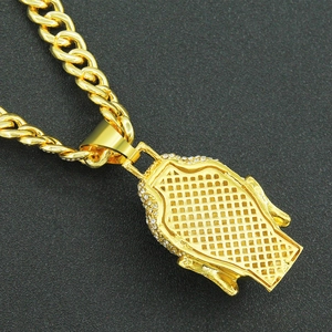 Detailed macro view of the gold Cuban chain necklace with a rhinestone-studded Buddha pendant