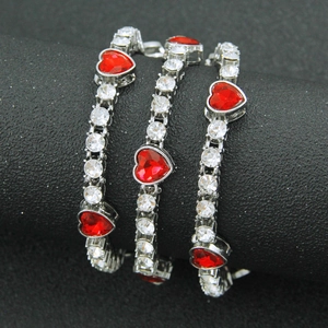 Iced out silver cuban link chain featuring red heart gemstones and sparkling crystals
