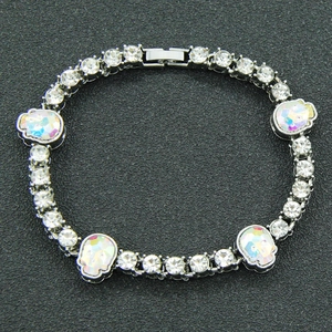 Detailed shot of silver skull charms with iridescent rhinestones on a punk link bracelet