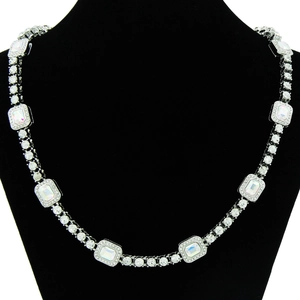 Detail of silver Cuban chain necklace with colorful rectangular crystals on black bust