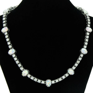 Detail view of hip-hop skull necklace with iridescent rhinestones on a black velvet display